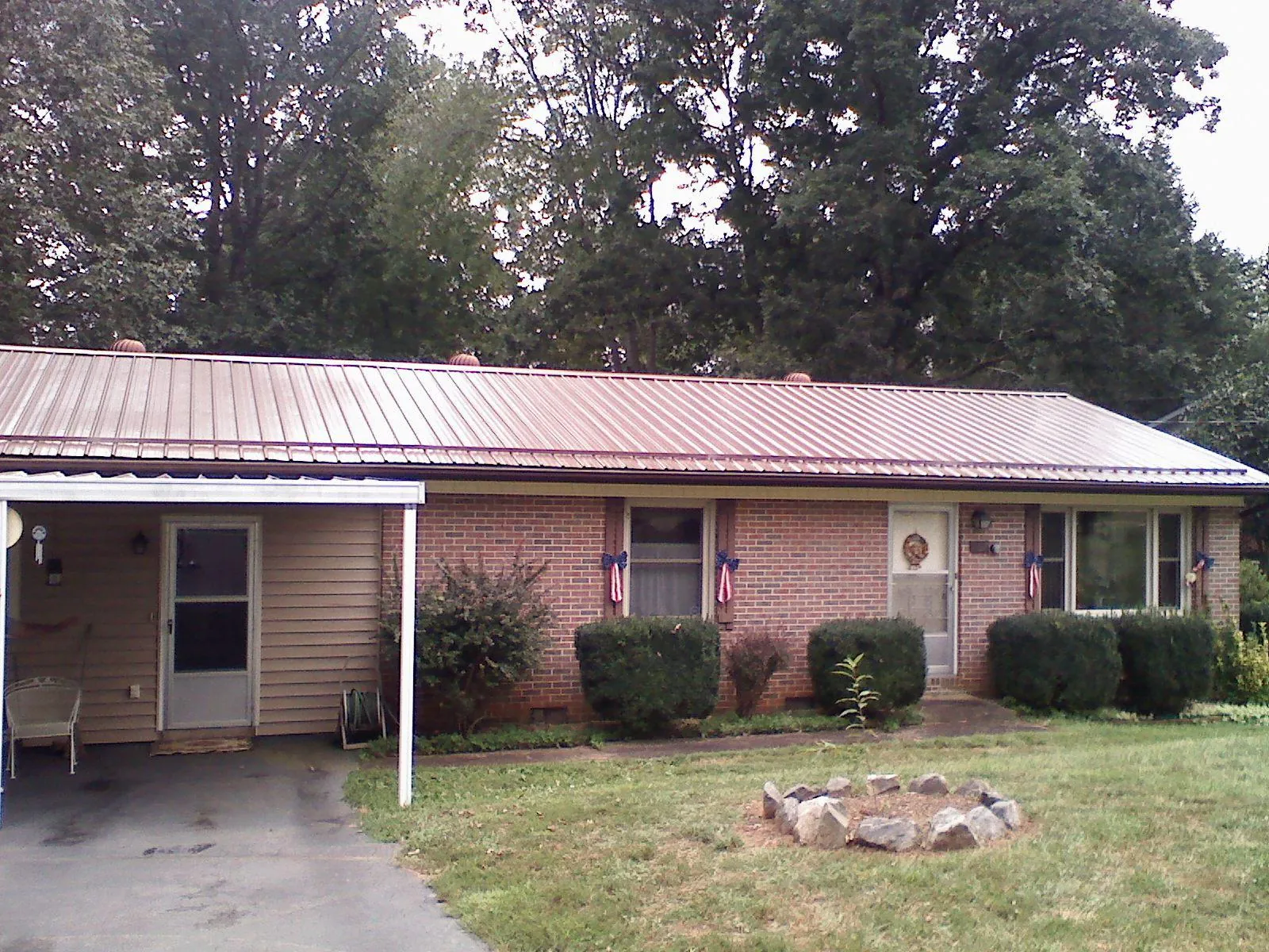 Bronze metal roof and carport on a brick ranch home — Roof Repair work by our crew in Longmeadow